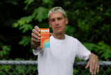 Man holding Sunii Energy Gum pack outdoors, showcasing the product