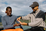 Two men sharing Sunii Energy Gum outdoors, highlighting the product’s portability and ease of use during outdoor activities